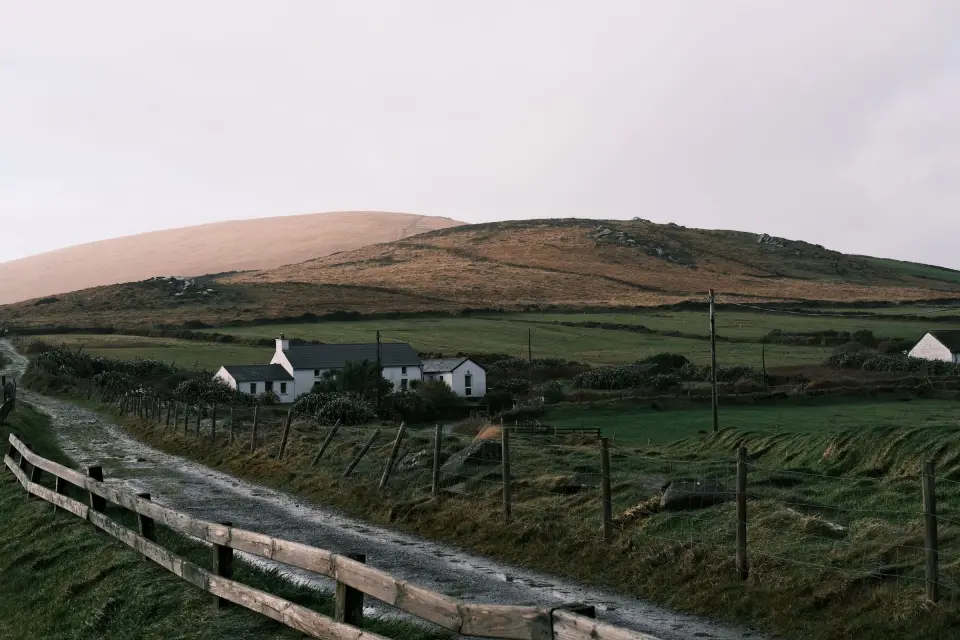 White farmhouses among green fields and hills in County Kerry