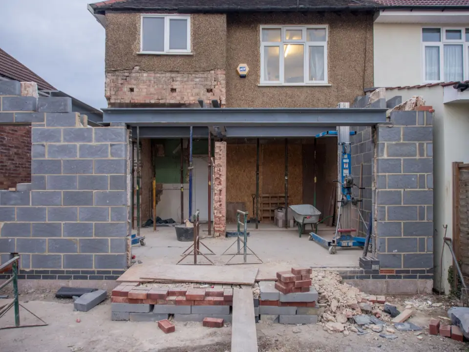A single-storey block extension under construction at the back of a semi-detached house